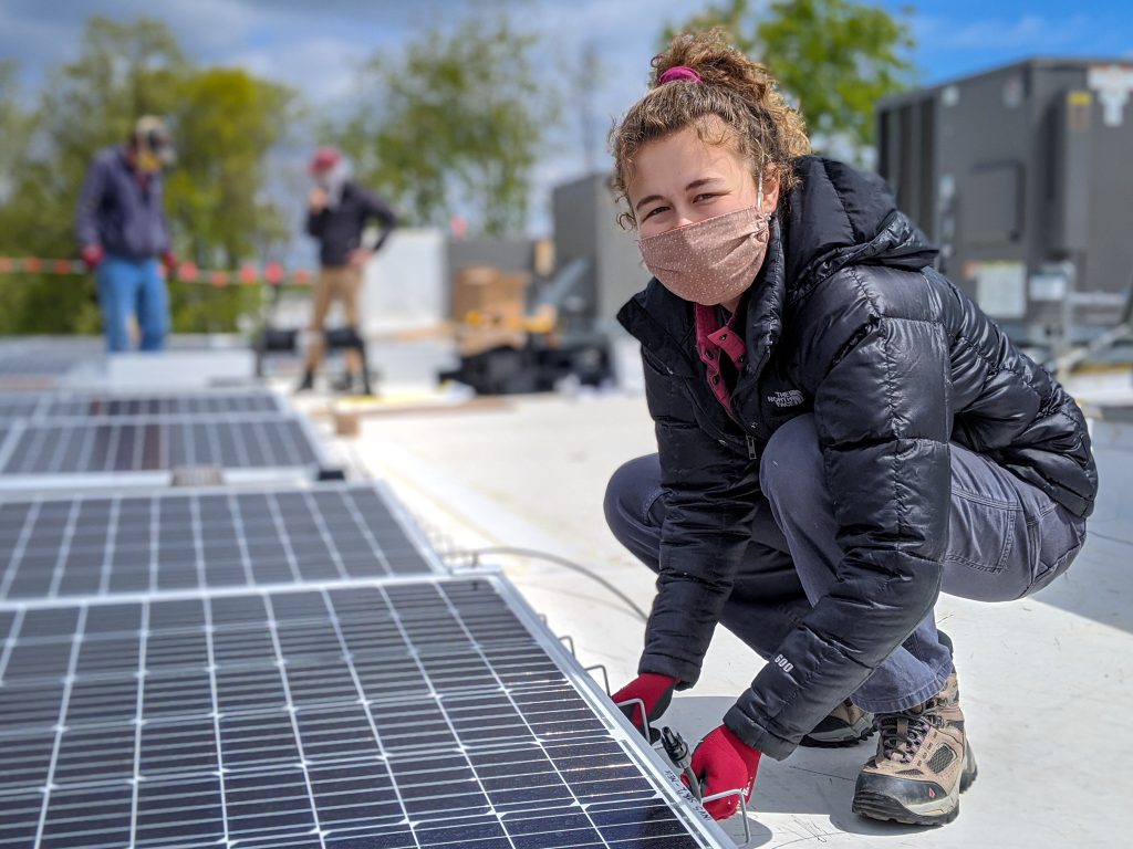 woman wearing mask installing solar