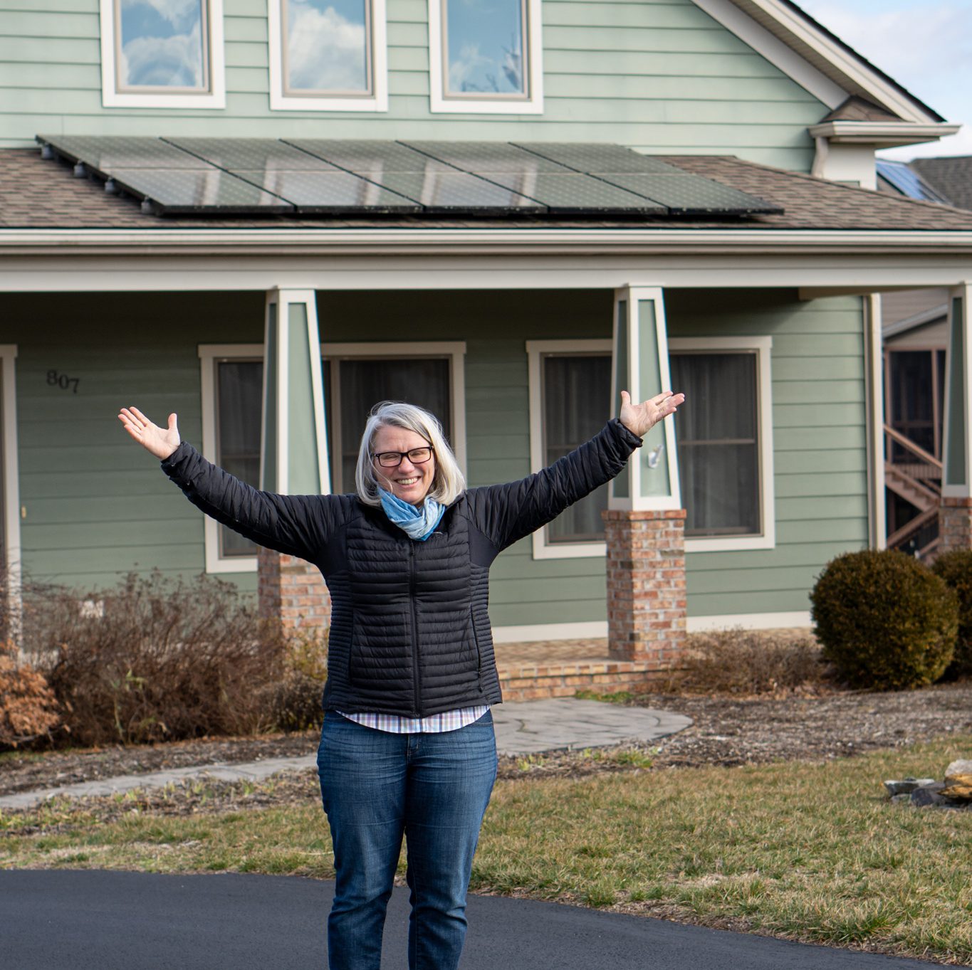 woman looking happy near solar array