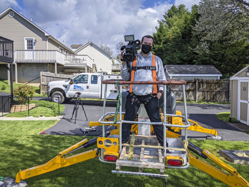 videographer standing in a lift bucket