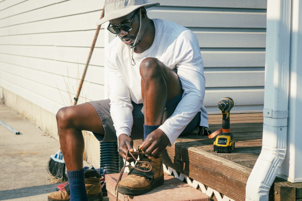 Solar installer putting on boots