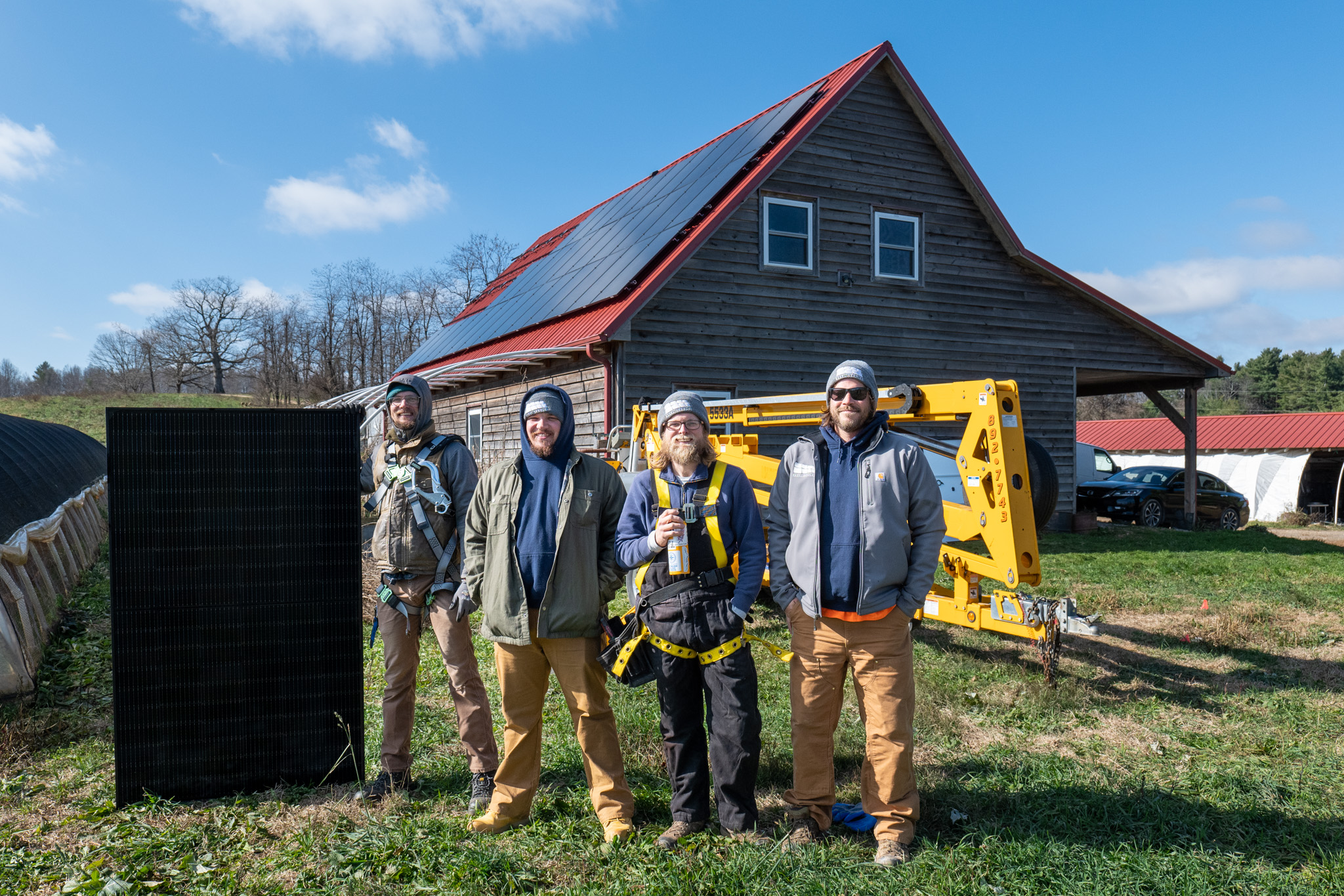 Solar installers posing in front of an array at Weathertop Farm